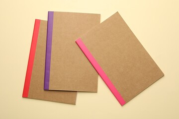 Fototapeta premium Different copybooks on beige background, flat lay
