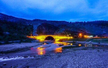 Night-time panorama of the Cendere Roman Bridge, close to the town of Adıyaman in Turkey.