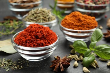 Different aromatic spices on grey table, closeup