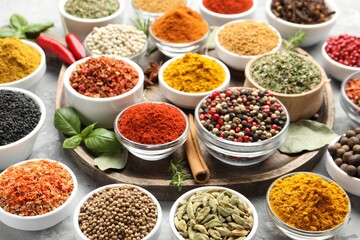 Different aromatic spices on grey table, closeup