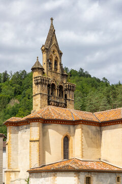 Church of Seix standing tall against a cloudy sky in the French Pyrenees