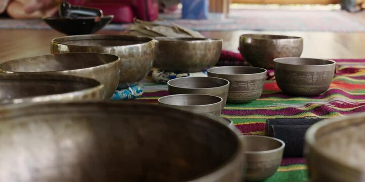 Tebet singing bowls stand on the floor before the start of the bowls ceremony