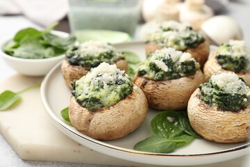 Tasty stuffed mushrooms served on light table, closeup