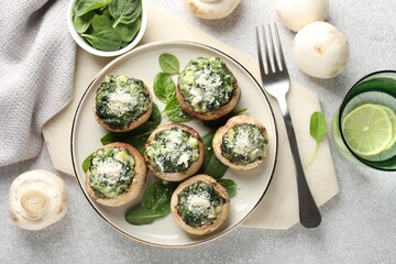 Tasty stuffed mushrooms served on light table, flat lay