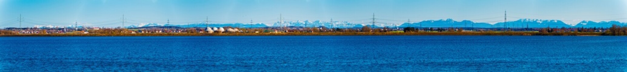 High resolution stitched alpine spring panorama on a sunny day at Ismaning Reservoir Lake, Munich,...