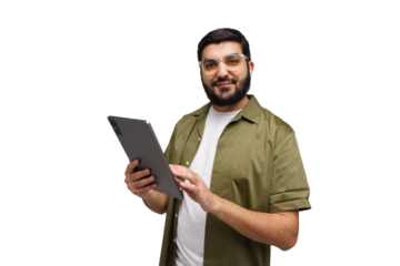 Engaging young man smiling while using a tablet in a modern, minimalistic setting