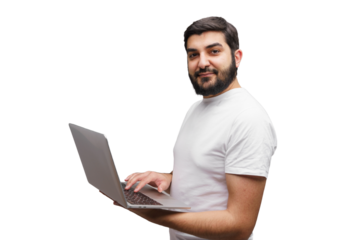 Man enthusiastically works on his laptop while standing, showcasing creativity in a minimalist setting
