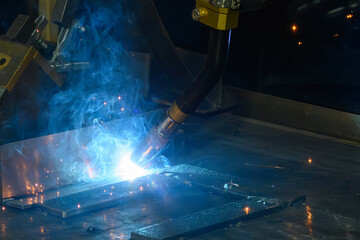 Close up scene the laser welding process by robotic system.