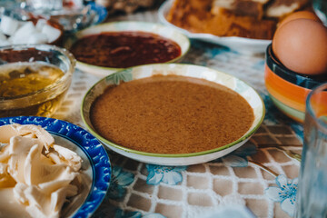 Traditional Moroccan breakfast with bread, olive oil, amlou, and argan oil
