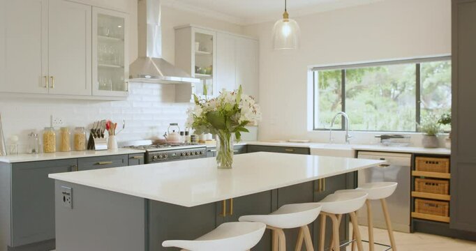 Modern kitchen with elegant island and fresh flowers, bright and inviting space, at home