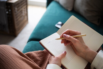 girl woman writes word goal in diary. concept of goal setting, planning, self-improvement and...