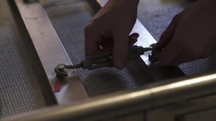 Detailed view of a professional camera lens with numerous connected cables and metal parts in a studio setup - Powered by Adobe