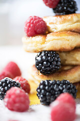 Close-up of pancakes with fresh raspberries and blackberries.