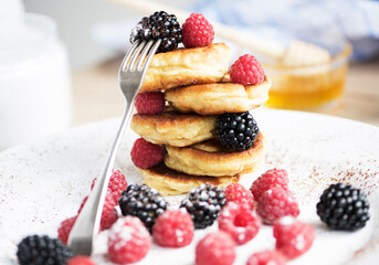 Delicious breakfast of pancakes with a bunch of fresh berries.