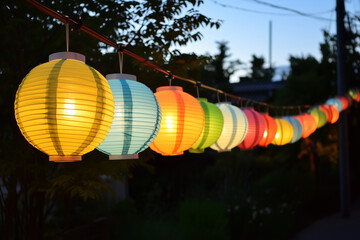 Illuminating Festival Lanterns: A vibrant row of colorful paper lanterns hangs gracefully, their soft glow creating a magical ambiance as dusk gently descends.