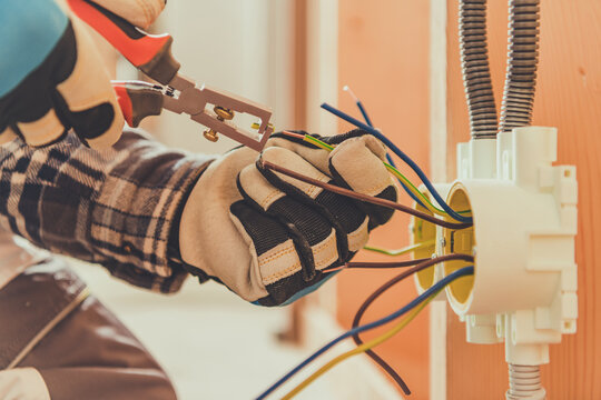 Electrician Working on Residential Wiring Indoors During the Day