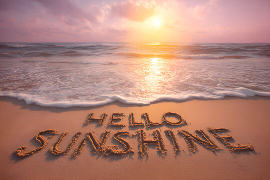 Hello sunshine written on beach at sunset welcoming summer