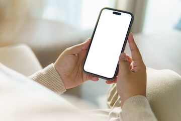 Close up of hands holding smartphone with blank white screen, for app mockups or UI design.