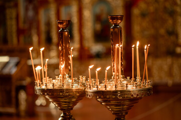 burning candles in a golden candlestick in an Orthodox church, faith, religion