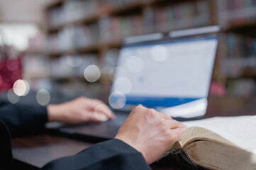 Intense Study Session Person Engrossed In Research At Quiet Desk With An Open Laptop And Book,...