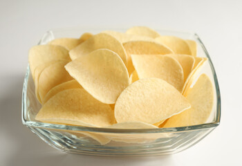 Tasty potato chips on white background, closeup