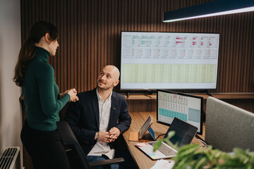 Business coworkers in a modern office holding a handshake in agreement