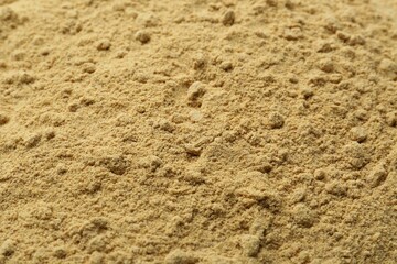 Superfood. Mustard seeds powder as background, closeup