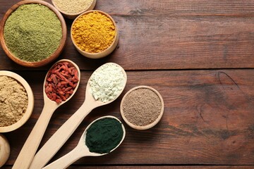 Different superfoods on wooden table, flat lay. Space for text