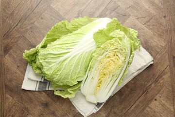 Fresh Chinese cabbages on wooden table, top view