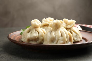 Delicious khinkali served on grey table, closeup