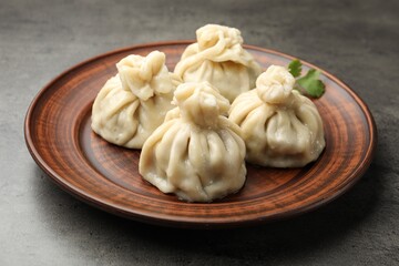 Delicious khinkali served on grey table, closeup