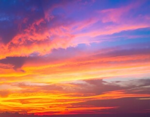 Obraz premium A vibrant sunset paints the sky in rich hues of blue and orange, with soft clouds scattered across, creating a stunning and serene atmosphere.