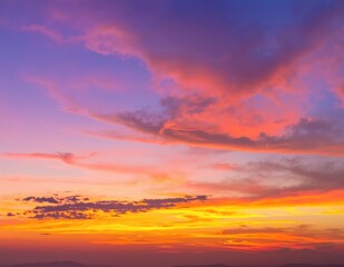 Fototapeta premium A stunning sunset paints the sky in vibrant shades of blue and orange, with wispy clouds adding texture to the breathtaking evening scene.