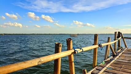 Fototapeta premium View of calm ocean waves under bright blue sky with beautiful clouds during the day