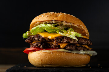 Close up of beef smach burger on dark surface