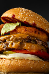 Close up of beef smach burger on dark surface hero view