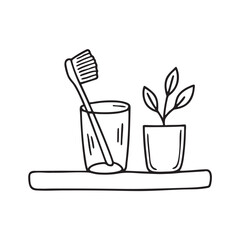 A toothbrush inside glass beside a small plant on the sink