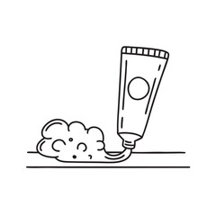 A toothpaste tube lying next to a foam trail on the counter