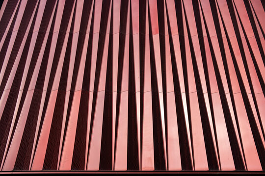 Detail of red vertical panels in an architectural facade, modern design and textures, ideal for contemporary architecture, urban design, and texture stock visuals.