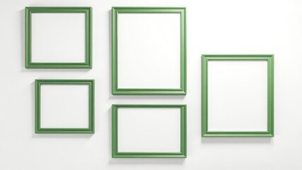 Collection of five blank picture frames with green trim arranged on a textured white wall providing space for creativity