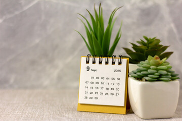 Hello, September 2025. Desktop calendar for planning on a gray background.
