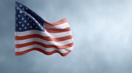Obraz premium An American flag flutters gracefully against a serene sky backdrop, symbolizing freedom, patriotism, and national pride in the United States.