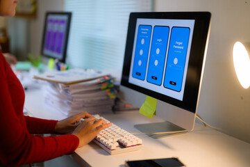 Web designer working on user interface design for mobile application using computer in office