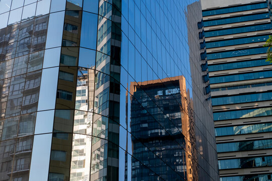 Skyscraper reflections on glass facades, modern urban textures and business architecture in cityscapes, ideal for design, office, and architectural stock imagery.