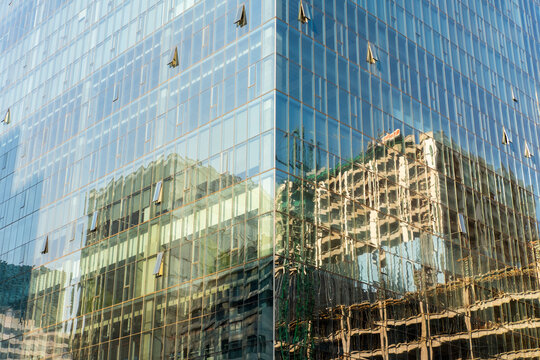 Abstract reflections on glass skyscrapers, modern architecture and urban design, ideal for business, office environments, and abstract background stock imagery.