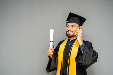 Happy graduate making a phone call after graduation ceremony