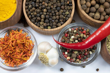 Assortment of spices in glassware and woodware close-up.