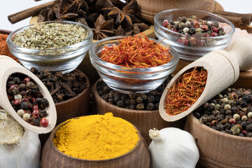 Spices in wooden and glass bowls close-up.