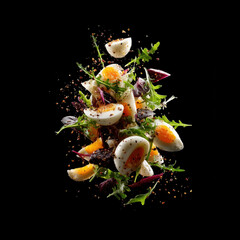 Fresh salad ingredients flying in the air