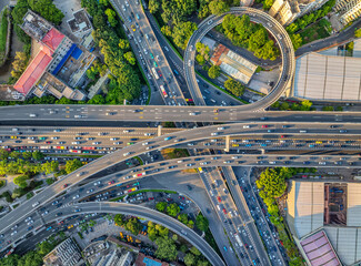 Aerial view of a complex urban highway interchange with flowing traffic in a modern city.